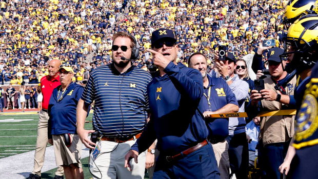 Sep 23, 2023; Ann Arbor, Michigan, USA; Michigan Wolverines head coach Jim Harbaugh leads his players before a game against the Rutgers Scarlet Knights at Michigan Stadium. Mandatory Credit: Rick Osentoski-USA TODAY Sports